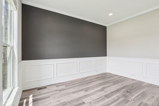 644 Ridge Gate Dr, Brownsburg, IN 46112 - spare room with a wainscoted wall, light wood-style floors, crown molding, recessed lighting, and a decorative wall