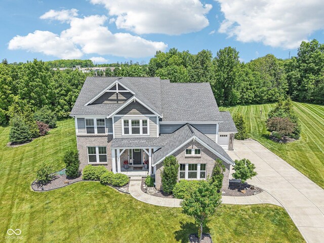 644 Ridge Gate Dr, Brownsburg, IN 46112 - view of front of house featuring a porch, concrete driveway, a front yard, and brick siding
