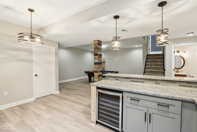 644 Ridge Gate Dr, Brownsburg, IN 46112 - kitchen featuring beverage cooler, baseboards, light wood-style floors, and decorative light fixtures