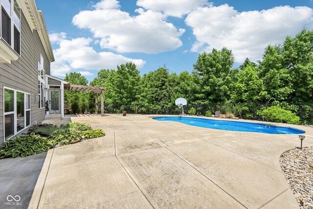 644 Ridge Gate Dr, Brownsburg, IN 46112 - outdoor pool with a patio area, a pergola, and view of wooded area