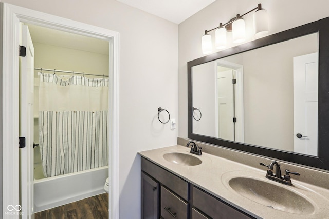 644 Ridge Gate Dr, Brownsburg, IN 46112 - full bath with double vanity, wood finished floors, shower / bathtub combination with curtain, and toilet
