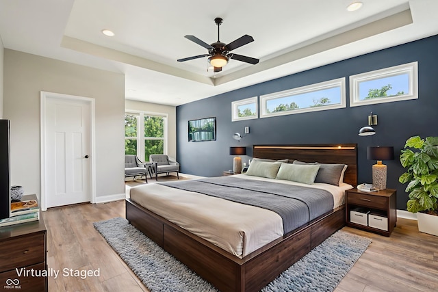 644 Ridge Gate Dr, Brownsburg, IN 46112 - bedroom with a tray ceiling, light wood finished floors, recessed lighting, baseboards, and a ceiling fan