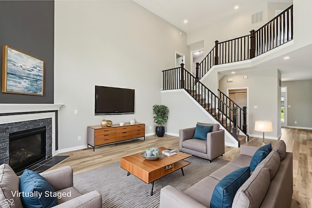 644 Ridge Gate Dr, Brownsburg, IN 46112 - living room featuring a high ceiling, stairs, wood finished floors, baseboards, and recessed lighting