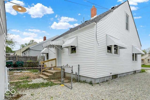 2015 S Hackley St, Muncie, IN 47302 - rear view of house featuring a chimney and roof with shingles