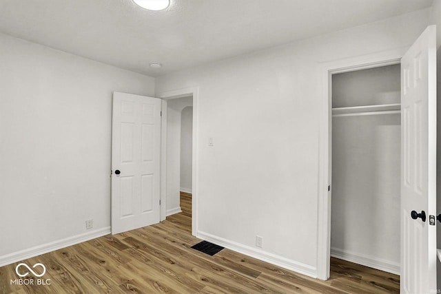 2015 S Hackley St, Muncie, IN 47302 - unfurnished bedroom featuring wood finished floors, a closet, and baseboards