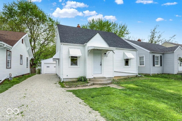 2015 S Hackley St, Muncie, IN 47302 - view of front of property with an outbuilding, a chimney, a front lawn, and roof with shingles
