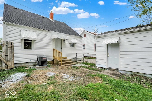 2015 S Hackley St, Muncie, IN 47302 - rear view of house featuring cooling unit, a chimney, and roof with shingles