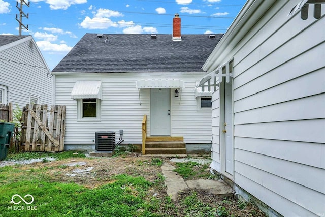 2015 S Hackley St, Muncie, IN 47302 - rear view of property with roof with shingles, central AC unit, and a chimney
