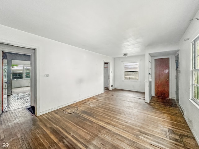 3615 N Dequincy St, Indianapolis, IN 46218 - unfurnished living room featuring wood finished floors and baseboards