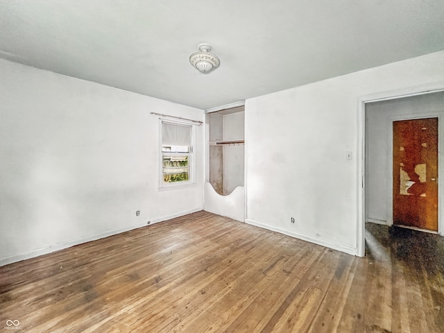3615 N Dequincy St, Indianapolis, IN 46218 - empty room with wood finished floors and baseboards