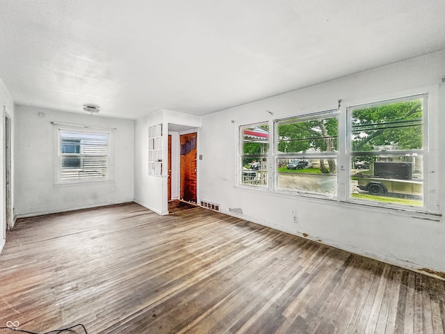3615 N Dequincy St, Indianapolis, IN 46218 - unfurnished living room featuring wood finished floors and baseboards