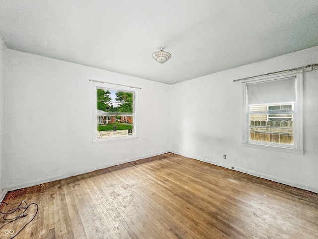 3615 N Dequincy St, Indianapolis, IN 46218 - empty room featuring hardwood / wood-style floors and baseboards