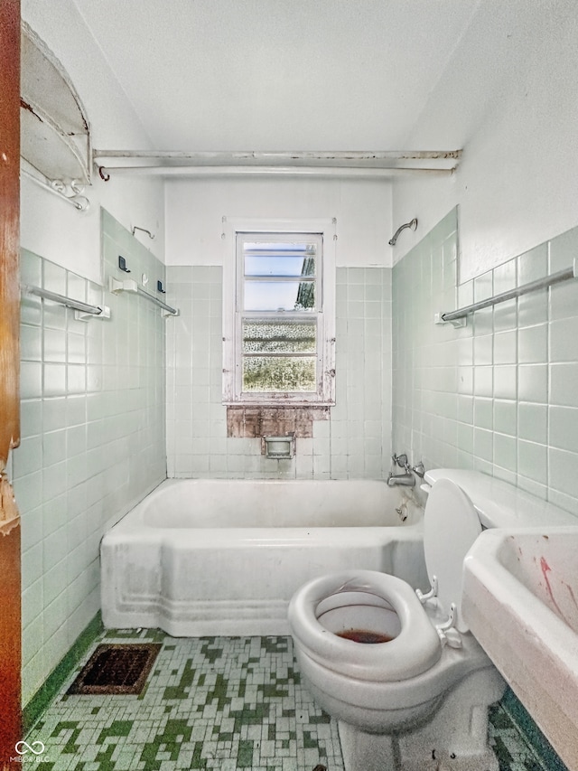 3615 N Dequincy St, Indianapolis, IN 46218 - bathroom featuring tile walls, toilet, and bathing tub / shower combination
