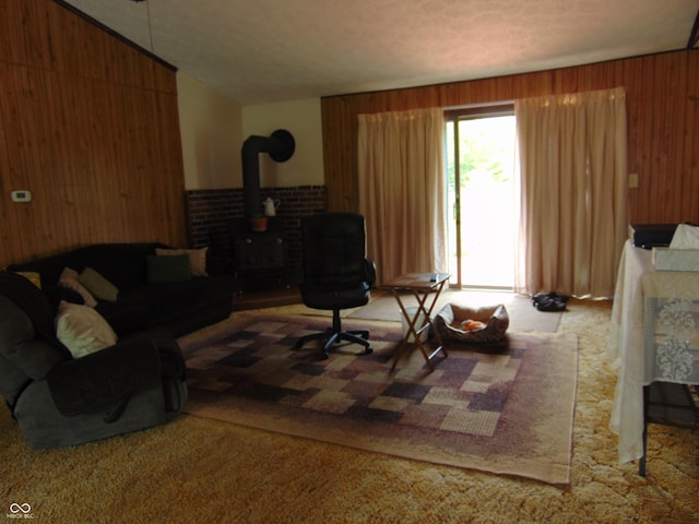 2625 S 200 E, Lebanon, IN 46052 - carpeted living room with a wood stove, wood walls, and lofted ceiling
