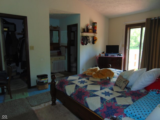 2625 S 200 E, Lebanon, IN 46052 - bedroom featuring a textured ceiling, a walk in closet, and ensuite bath