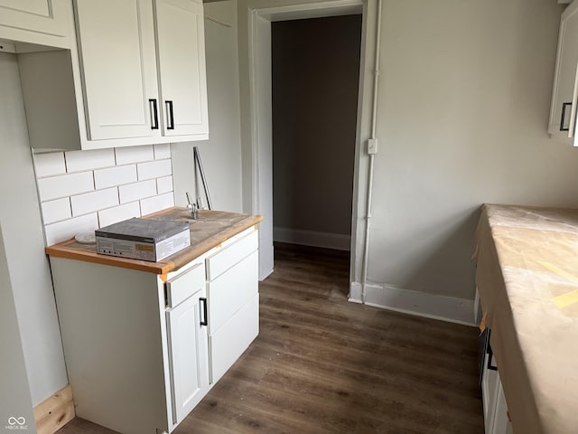 621 E Main St, Muncie, IN 47305 - kitchen featuring dark wood finished floors, decorative backsplash, baseboards, white cabinetry, and wood counters