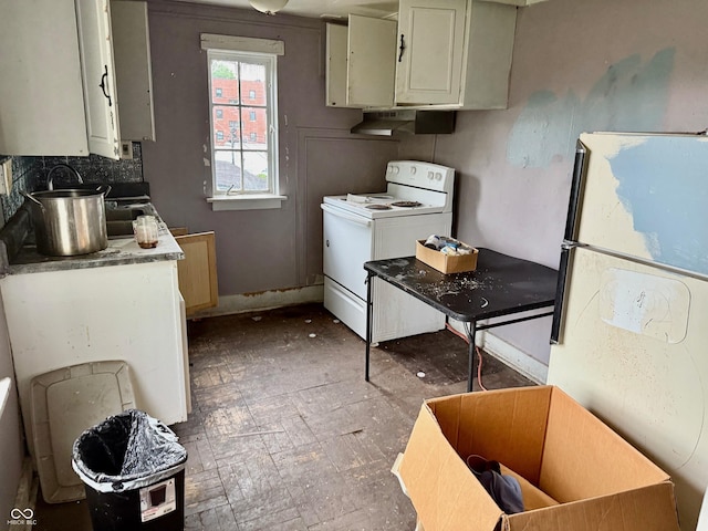 621 E Main St, Muncie, IN 47305 - kitchen with white appliances, under cabinet range hood, decorative backsplash, and baseboards