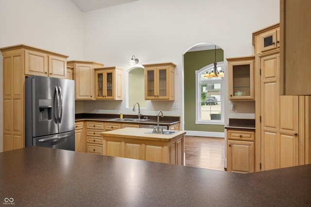 435 Cedar View Ln, Bedford, IN 47421 - kitchen featuring stainless steel fridge with ice dispenser, a sink, a center island with sink, a chandelier, and a towering ceiling
