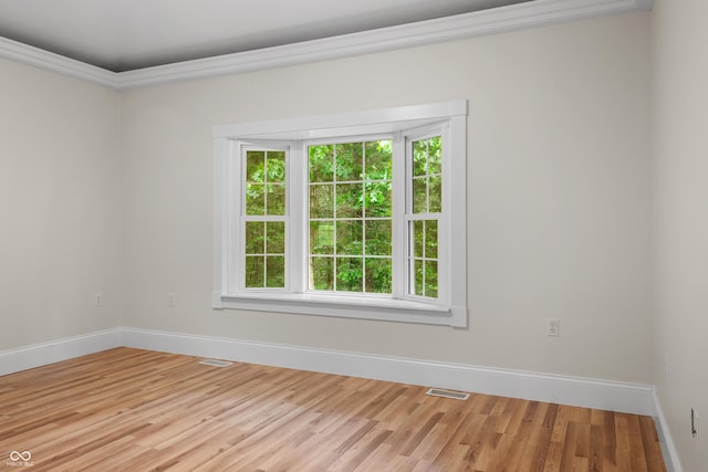 435 Cedar View Ln, Bedford, IN 47421 - spare room featuring baseboards, crown molding, and light wood-style floors