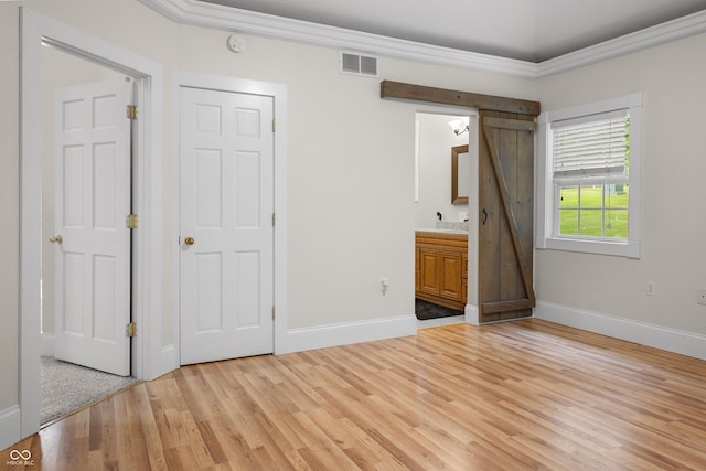 435 Cedar View Ln, Bedford, IN 47421 - unfurnished bedroom with light wood finished floors, baseboards, ornamental molding, and ensuite bath
