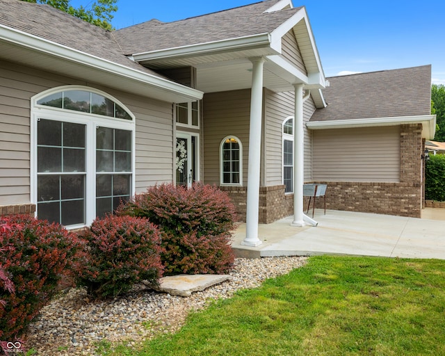 435 Cedar View Ln, Bedford, IN 47421 - entrance to property with roof with shingles, brick siding, covered porch, and a yard
