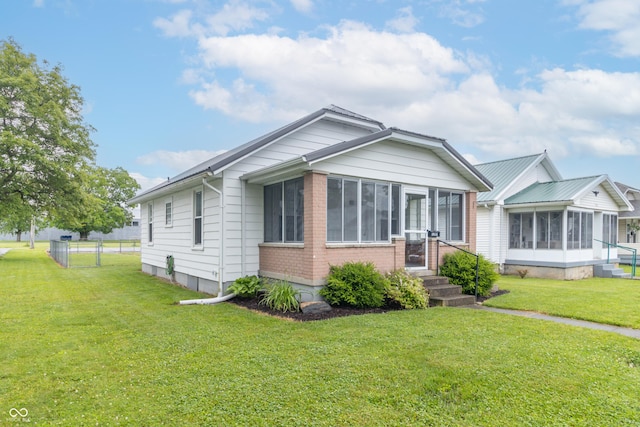1310 N Cherry St, Rushville, IN 46173 - view of front facade featuring a sunroom and brick siding