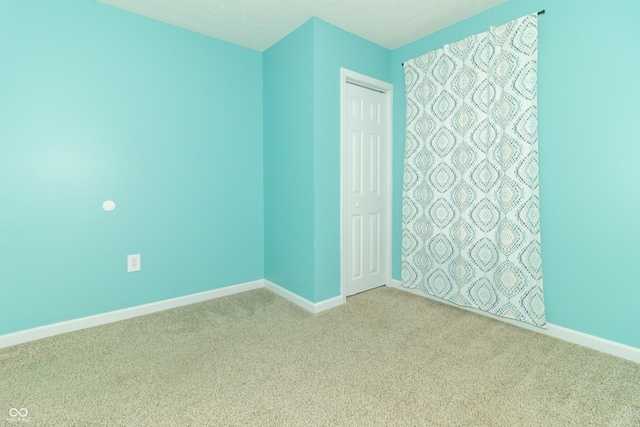 1310 N Cherry St, Rushville, IN 46173 - empty room featuring carpet floors and baseboards