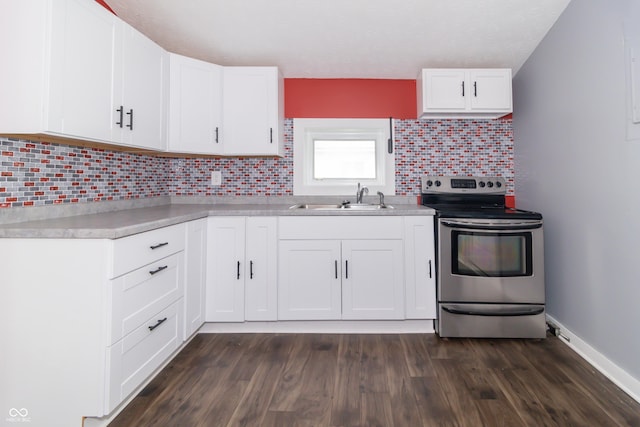 1310 N Cherry St, Rushville, IN 46173 - kitchen featuring electric stove, backsplash, light countertops, white cabinets, and dark wood-style floors