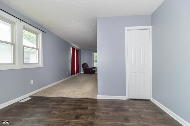1310 N Cherry St, Rushville, IN 46173 - unfurnished room featuring plenty of natural light, a textured ceiling, and dark wood-style flooring