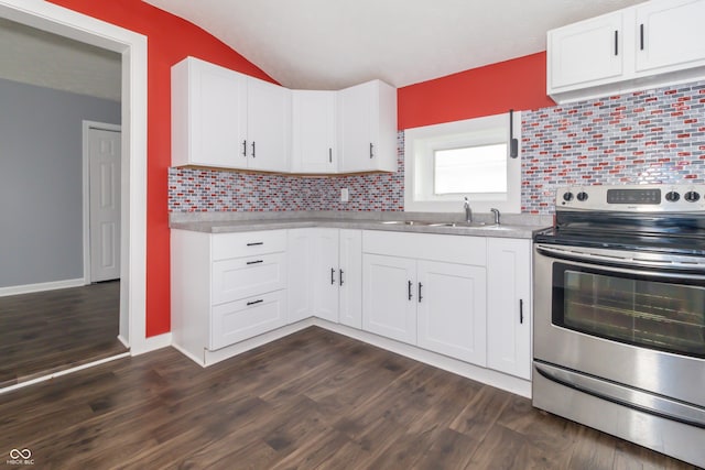 1310 N Cherry St, Rushville, IN 46173 - kitchen with stainless steel electric stove, light countertops, white cabinetry, decorative backsplash, and lofted ceiling