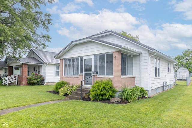 1310 N Cherry St, Rushville, IN 46173 - view of front of home with a front yard and brick siding