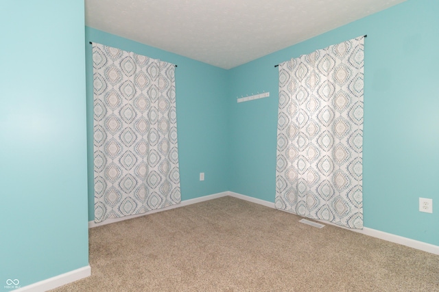 1310 N Cherry St, Rushville, IN 46173 - carpeted spare room with baseboards and a textured ceiling