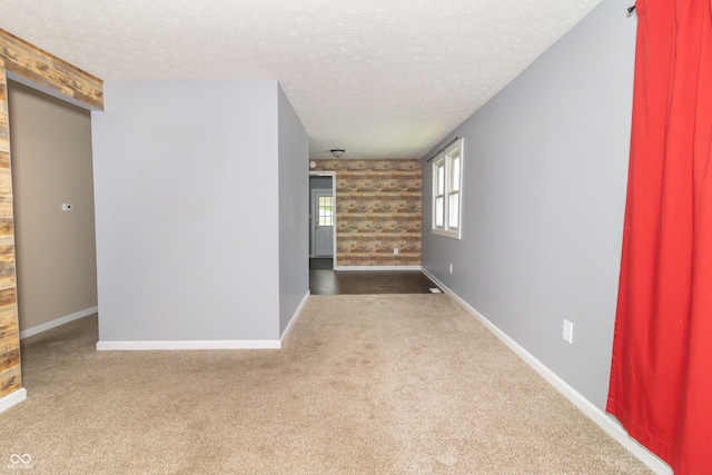 1310 N Cherry St, Rushville, IN 46173 - carpeted spare room featuring a textured ceiling and baseboards