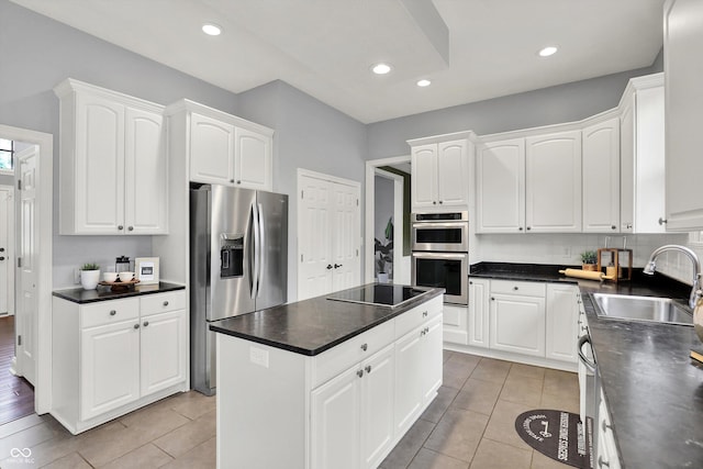 1410 Shadow Ct, Zionsville, IN 46077 - kitchen with appliances with stainless steel finishes, a kitchen island, dark countertops, white cabinets, and light tile patterned flooring