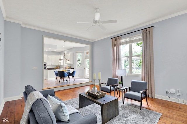 1410 Shadow Ct, Zionsville, IN 46077 - living area featuring light wood finished floors, ceiling fan, and crown molding