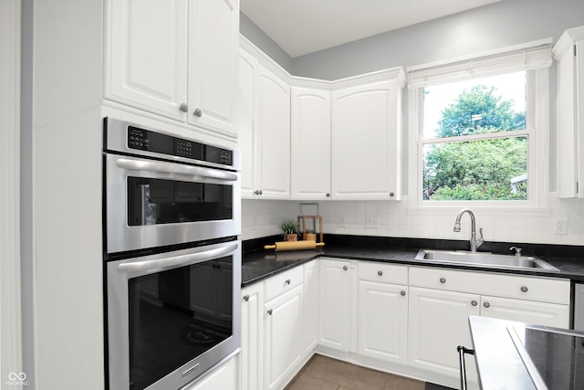 1410 Shadow Ct, Zionsville, IN 46077 - kitchen with double oven, dark countertops, white cabinetry, and backsplash