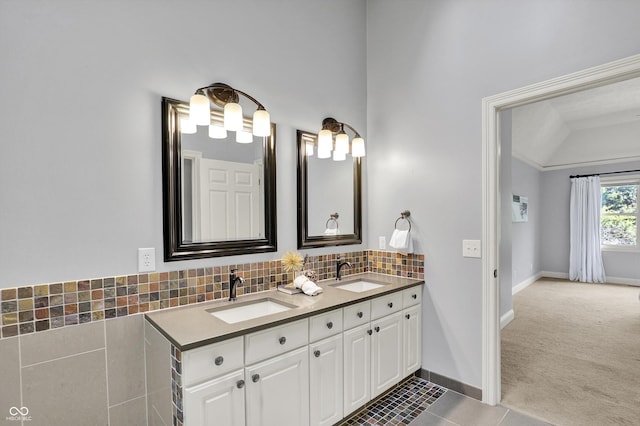 1410 Shadow Ct, Zionsville, IN 46077 - bathroom with double vanity, vaulted ceiling, backsplash, and tile patterned floors
