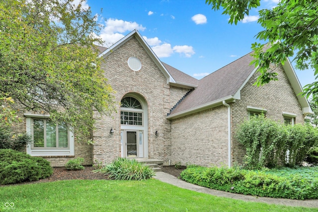 1410 Shadow Ct, Zionsville, IN 46077 - traditional home featuring brick siding, roof with shingles, and a front lawn