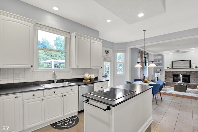 1410 Shadow Ct, Zionsville, IN 46077 - kitchen featuring stainless steel dishwasher, dark countertops, black electric cooktop, light tile patterned floors, and a brick fireplace