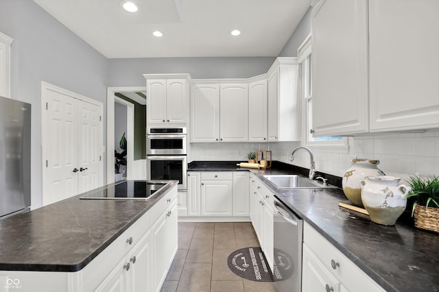1410 Shadow Ct, Zionsville, IN 46077 - kitchen featuring stainless steel appliances, white cabinets, tasteful backsplash, light tile patterned flooring, and recessed lighting