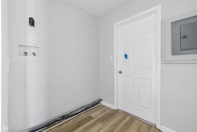 903 Sunset Dr, Lebanon, IN 46052 - laundry room featuring electric panel, washer hookup, wood finished floors, and baseboards