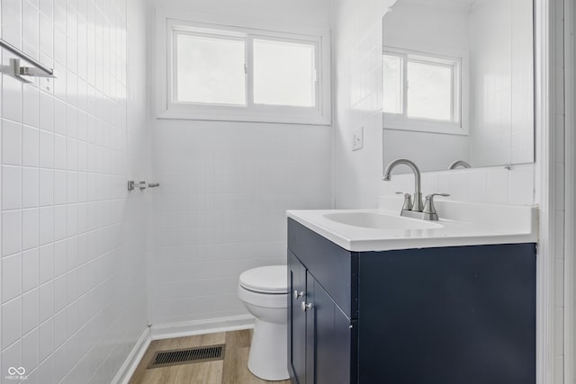 903 Sunset Dr, Lebanon, IN 46052 - bathroom featuring vanity, toilet, tile walls, and wood finished floors