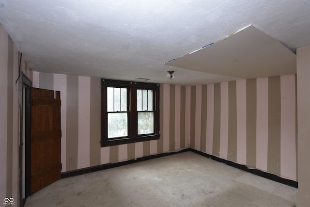 364 S Cole St, Indianapolis, IN 46241 - unfurnished room with baseboards, unfinished concrete floors, and wallpapered walls