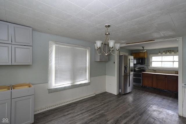 364 S Cole St, Indianapolis, IN 46241 - kitchen featuring appliances with stainless steel finishes, baseboard heating, a chandelier, dark wood-type flooring, and decorative light fixtures
