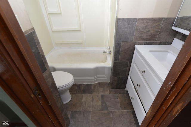 364 S Cole St, Indianapolis, IN 46241 - bathroom featuring vanity, toilet, shower / bathtub combination, and tile walls
