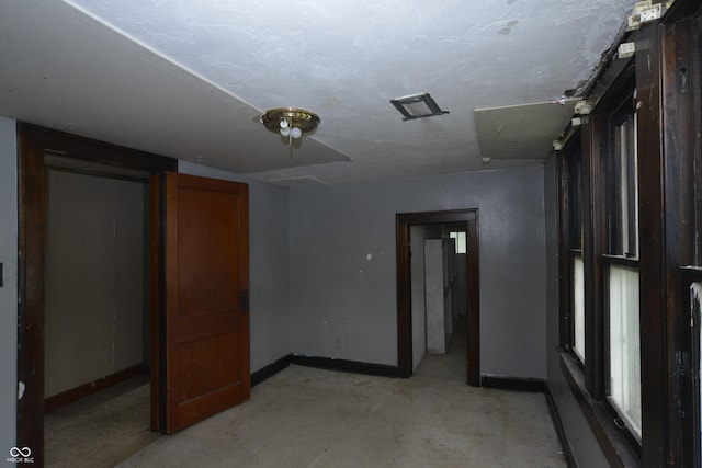 364 S Cole St, Indianapolis, IN 46241 - unfurnished bedroom with baseboards and unfinished concrete floors