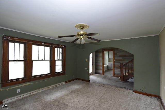 364 S Cole St, Indianapolis, IN 46241 - carpeted empty room featuring arched walkways, baseboards, stairs, crown molding, and a ceiling fan