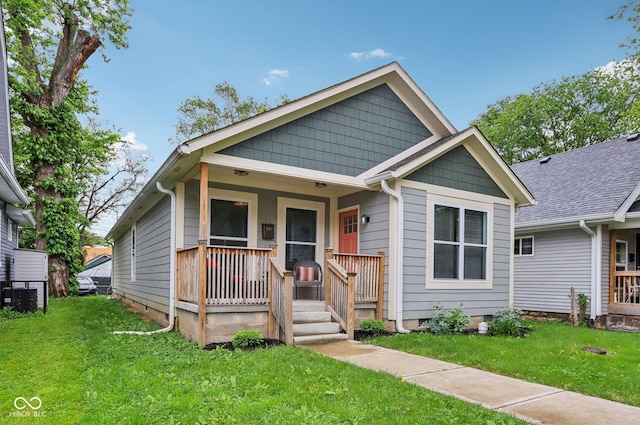 617 N Dearborn St, Indianapolis, IN 46201 - view of front of property featuring covered porch, a front yard, and central AC unit