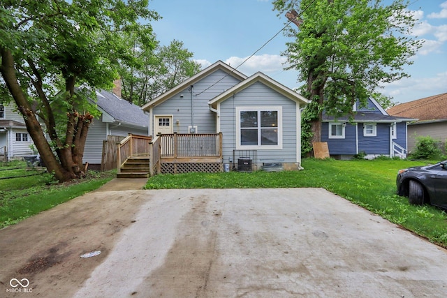 617 N Dearborn St, Indianapolis, IN 46201 - rear view of property featuring a wooden deck, a lawn, and central AC