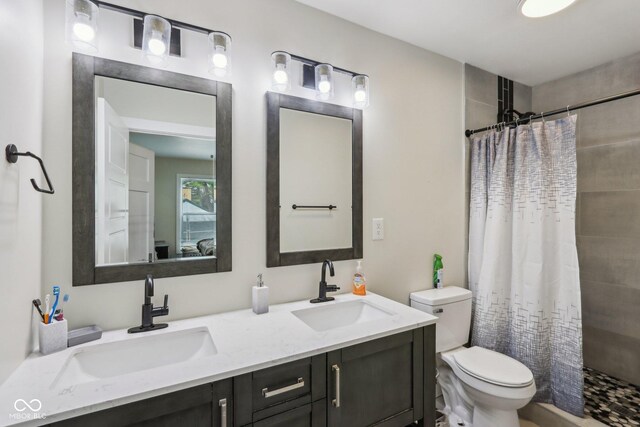 617 N Dearborn St, Indianapolis, IN 46201 - bathroom with toilet, tiled shower, and double vanity